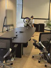 Crew member vacuuming a Dallas-Fort Worth conference room after business hours