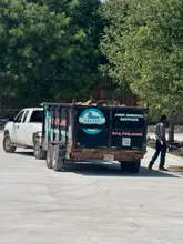 Daltex junk removal trailer and service truck loaded with debris on a Dallas-Fort Worth job