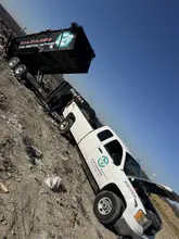 Daltex truck and dump trailer loaded with debris at a Dallas-Fort Worth job site