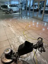 Floor scrubber cleaning tile in Dallas-Fort Worth with the uncleaned surface still visible alongside