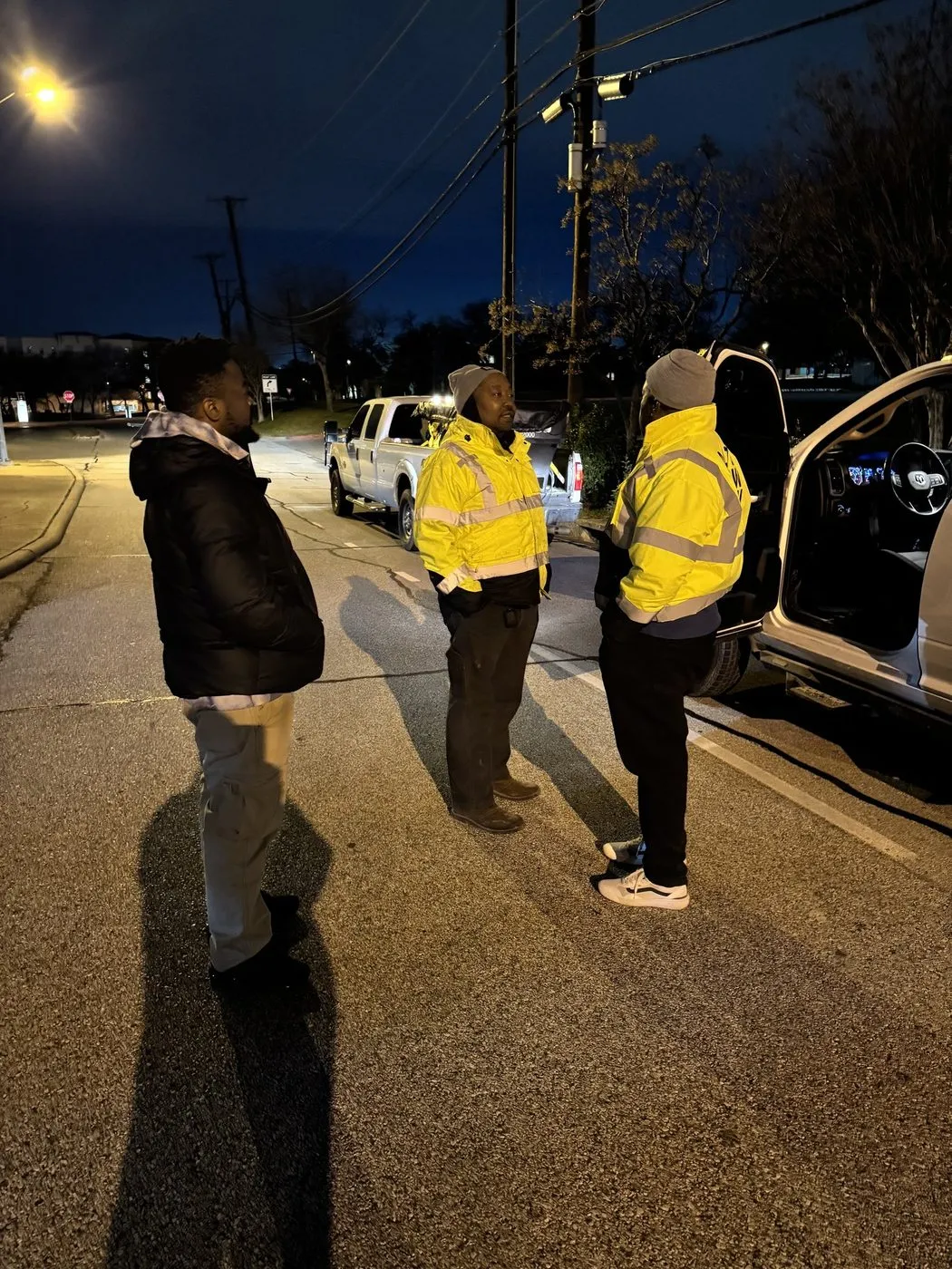 Daltex crew in high visibility gear treating a Dallas-Fort Worth property at night