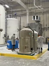 Daltex crew in protective suits cleaning around industrial tanks in Dallas-Fort Worth