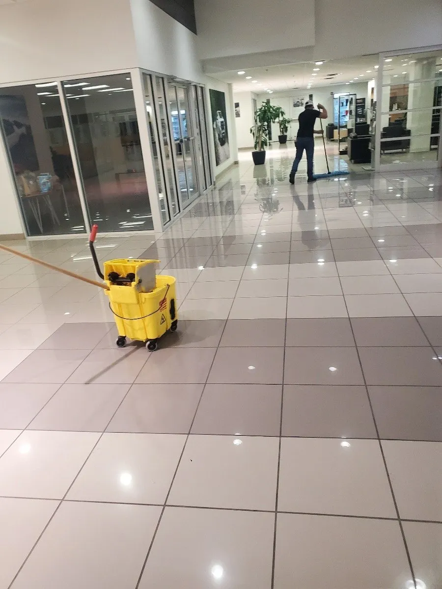 Mop bucket in a Dallas-Fort Worth commercial corridor with freshly cleaned tile floors