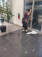 Crew member mopping a glossy entrance floor at a Dallas-Fort Worth commercial building