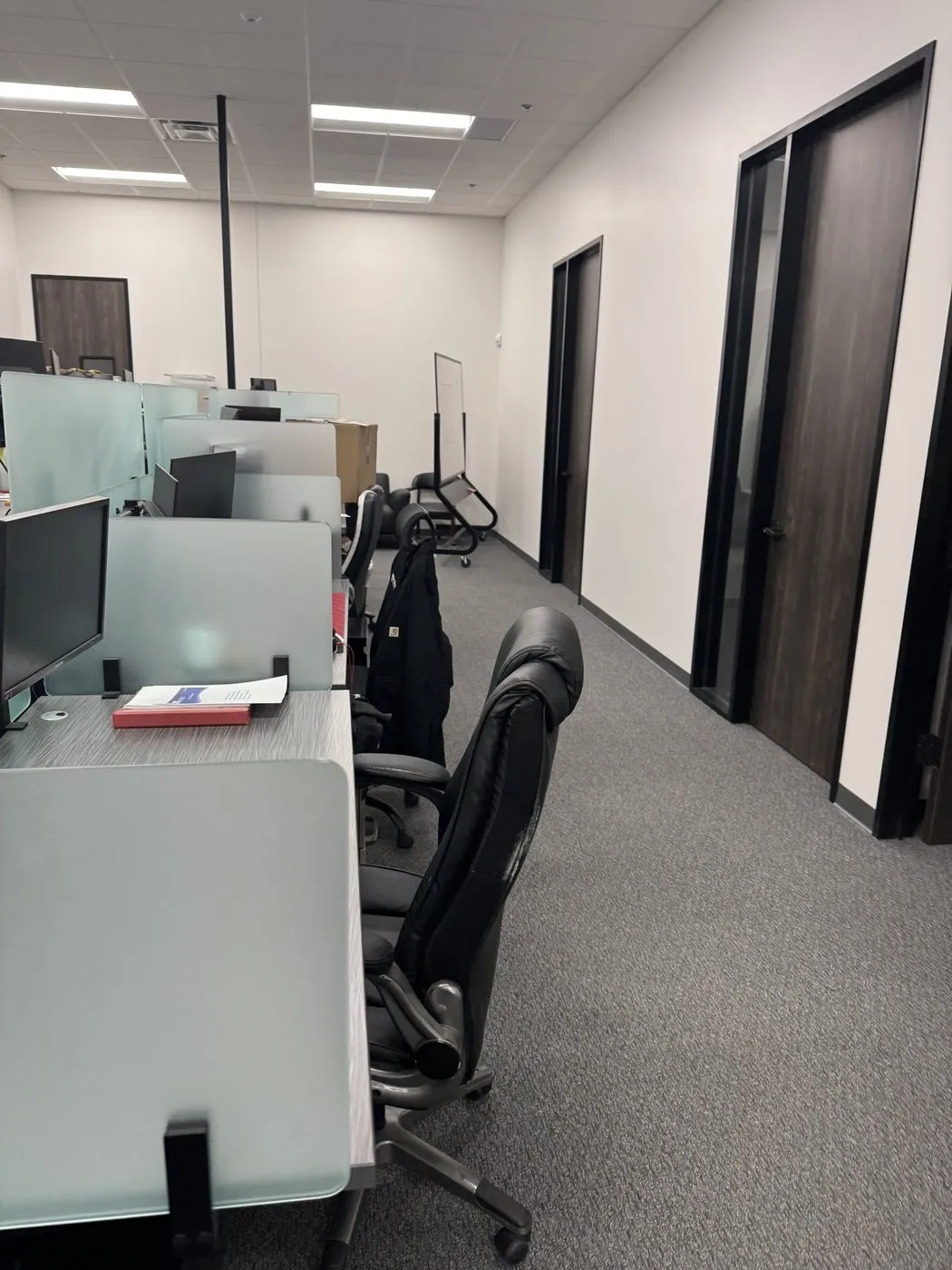 Office workstations and glass dividers with freshly vacuumed carpet in Dallas-Fort Worth