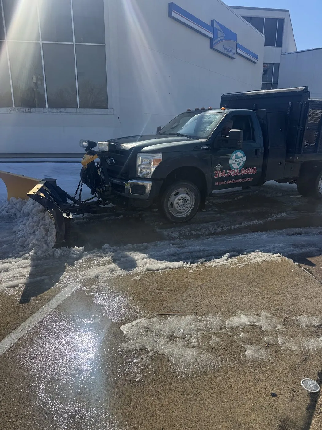 Daltex truck with plow equipment at an icy Dallas-Fort Worth commercial property
