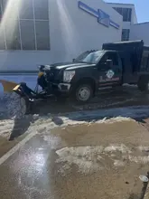 Daltex truck with plow equipment at an icy Dallas-Fort Worth commercial property